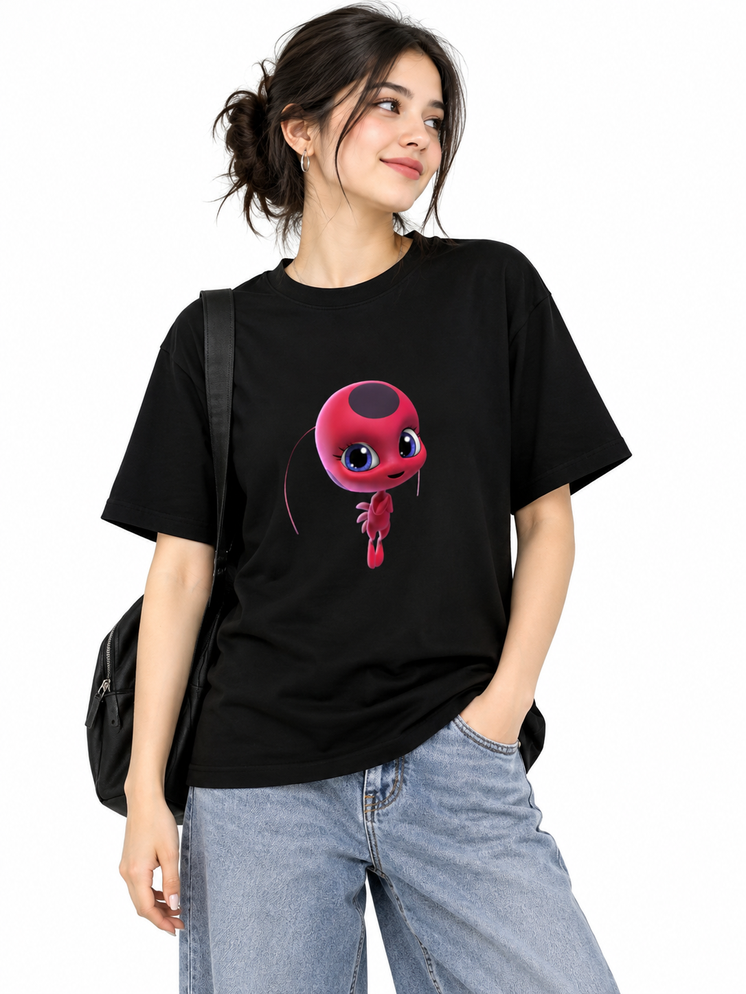A classic black crewneck graphic t-shirt featuring Tikki, the Ladybug Kwami from Miraculous: Tales of Ladybug & Cat Noir.